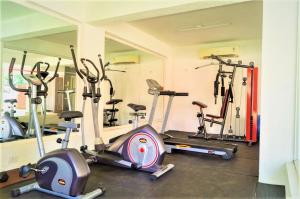 a gym with several exercise bikes in a room at Premium 2 BHK Green Suites in Arpora