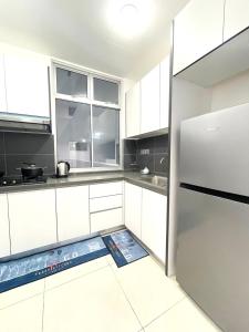 a kitchen with white cabinets and a refrigerator at SKS Habitat 461 2BR 4-5pax Larkin Johor Bahru in Johor Bahru