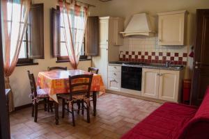 a kitchen with a table and chairs in a room at Room in Holiday house - Apartment in Farmhouse Casolare dei Fiori in Chiesina Uzzanese