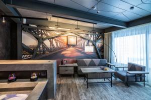 a living room with a bridge mural on the wall at Kamarooms Business Hotel & Spa in Naberezhnyye Chelny