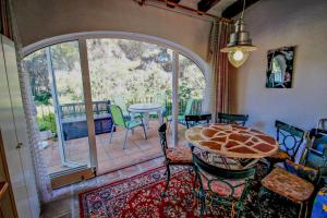 a room with a patio with a table and chairs at Moraira Park - charming cottage in Moraira in Teulada