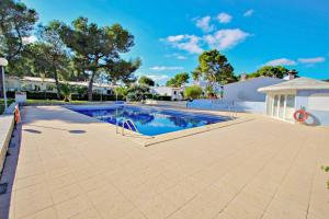 a swimming pool in a yard with trees and a building at Moraira Park - charming cottage in Moraira in Teulada