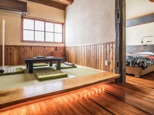 a room with a bed and a table in it at Kunugi Relaxation with 4 modern rooms in Hakuba +148 photos