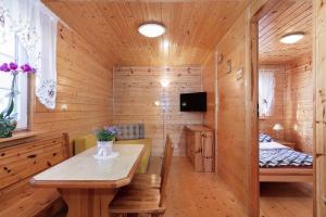 a room with a wooden cabin with a table and a bed at holiday home in Domyslow by Kolczewo the perfect place for two guests in Kołczewo