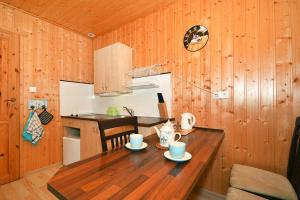 a wooden kitchen with a wooden table in a room at Holiday resort, Wicie in Wicie