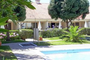 a house with a swimming pool in the yard at Holiday resort Clube Pinhal da Foz, Esposende, Studio for 2 pers in Esposende