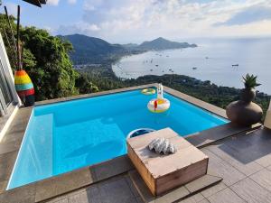 a swimming pool with a view of the ocean at Priscilla Villa in Koh Tao