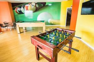 a foosball table in a room with a pool table at Gaboardi Park Hotel in Curitibanos