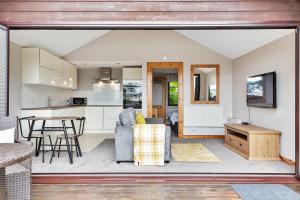 a kitchen and living room with a couch and a table at Hamble Retreat Studios and Lodge in Warsash +37 photos