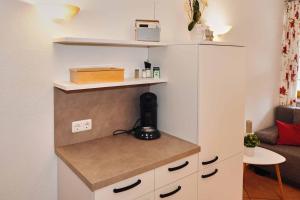 a room with a white cabinet with a counter at Restaurant - Garni bei Peppo in Ebern