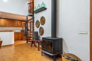 a fireplace in a living room with a stove at Villa Can Cova Camp in San Antonio