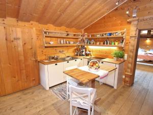 a kitchen with a table in a wooden cabin at Farmhouse with views over the valley in Rauris