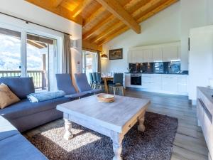 a living room with a couch and a table at Apartment in Piesendorf in ski area with sauna in Piesendorf