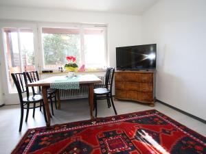 a living room with a table and a television at Apartment near the ski area in Sankt Michael im Lungau