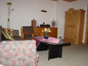 a living room with a couch and a table with flowers on it at Apartment near the ski area in Obsteig in Obsteig
