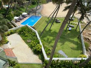 an overhead view of a swimming pool with palm trees at Rockholm at the Light House Beach in Kovalam