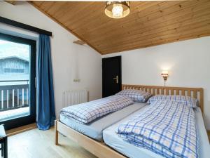 A bed or beds in a room at Apartment in Niedernsill near Zell am See Ski Lift