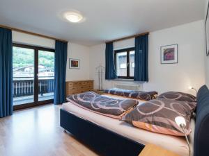 A bed or beds in a room at Apartment in Niedernsill near Zell am See Ski Lift