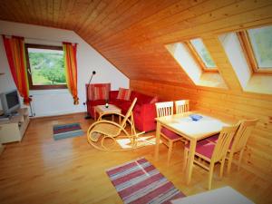 a living room with a table and a couch at Apartment in Koettmannsdorf near bathing lake in Wurdach