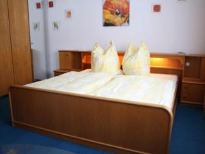 a large bed with yellow pillows in a room at Apartment in Taxenbach with Garden Garden Furniture BBQ in Taxenbach