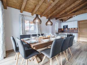 a dining room with a wooden table and chairs at Sunny holiday home with sauna in Piesendorf in Piesendorf