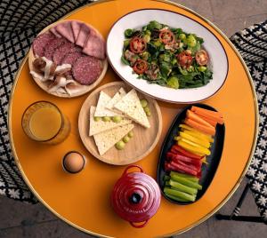 a table topped with two plates of food and a salad at Bazzar Boutique Hotel in Tbilisi City +50 photos