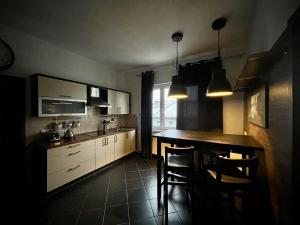 a kitchen with a table and some chairs in it at Stylové apartmánky in Frýdek-Místek