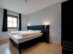 - une chambre avec un lit et une fenêtre dans l'établissement Holiday home in ski area in Mauterndorf with sauna, à Begöriach