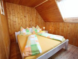 a bedroom with a bed in a wooden room at Chalet in Prebl Carinthia with sauna near ski area in Prebl