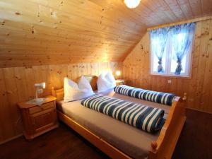 ein Schlafzimmer mit einem Bett in einem Blockhaus in der Unterkunft Chalet in Prebl Carinthia with sauna near ski area in Prebl