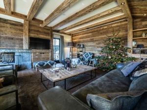 a living room with a christmas tree and a couch at Premium chalet in Wagrain with 2 saunas and pool in Wagrain