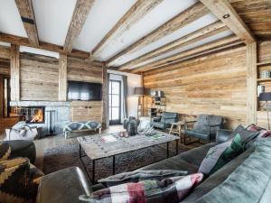 a living room with a couch and a fireplace at Premium chalet in Wagrain with 2 saunas and pool in Wagrain