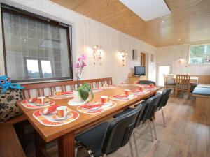 a dining room with a large wooden table and chairs at Wonderful holiday home with mountain views in Altenmarkt im Pongau
