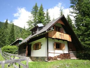 a small house in the middle of a field at Spacious Alpine Hut in Bad Kleinkirchheim with Garden in Bad Kleinkirchheim