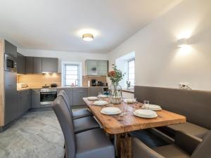 a kitchen with a wooden table and some chairs at Maisonette in St Michael Lungau near Katschberg in Sankt Michael im Lungau