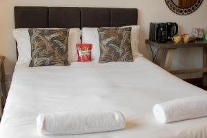 a large white bed with two pillows on it at OYO The Old Mill in Yarm