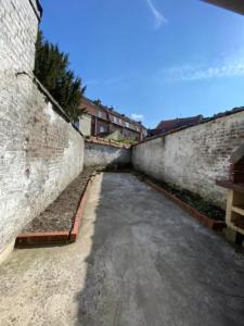 un callejón vacío entre dos paredes de ladrillo en NG SuiteHome - Lille I Roubaix Rémy Cogghe - Studio - Netflix - Wifi en Roubaix