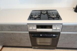 a stove top oven in a kitchen next to a counter at AP Yours 401 in Okinawa City
