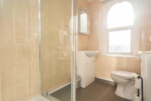 a bathroom with a toilet and a glass shower at Lauriston Hotel in Weston-super-Mare