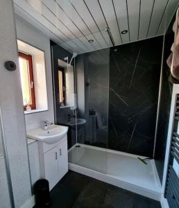 a bathroom with a tub and a sink and a shower at Premium Ground Floor Apartment, Near Fort William Town Centre in Fort William