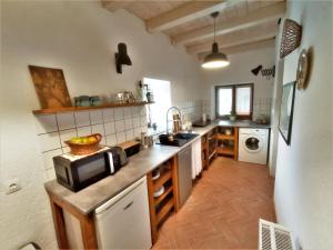 a kitchen with a sink and a microwave on a counter at 400 Éves Ház Vendégház in Kőszegszerdahely