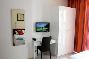 1 dormitorio con escritorio, silla y cama en Atlantis Lodge, en Marsalforn
