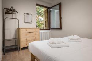 een slaapkamer met een bed, een dressoir en een spiegel bij Flats4Rent Irene in Verona