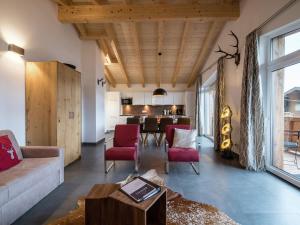 a living room with a couch and a table at Chalet apartment in ski area in Piesendorf in Piesendorf