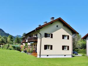 a large white house with a green lawn at Charming Apartment in Kitzbuhel with Balcony in Kitzbühel
