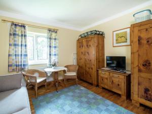 a living room with a table and a tv at Charming Apartment in Kitzbuhel with Balcony in Kitzbühel