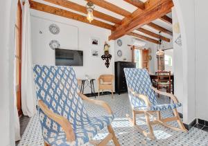 a living room with two chairs and a tv at Alvaro Oliver House by Slow Villas in Porto Cristo +24 photos