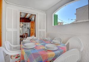 a white dining room with a table and chairs at Alvaro Oliver House by Slow Villas in Porto Cristo