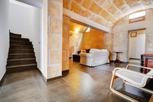 a living room with a white couch and a staircase at Amilcar House by Slow Villas in Palma de Mallorca