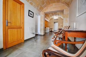 a dining room with a table and chairs and a door at Amilcar House by Slow Villas in Palma de Mallorca +18 photos